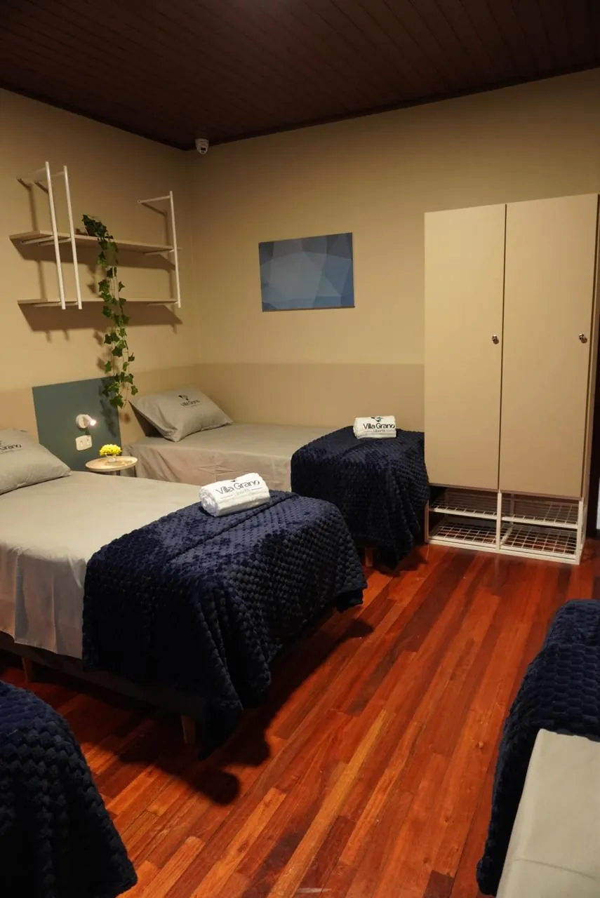 Quarto com camas de solteiro e armário branco